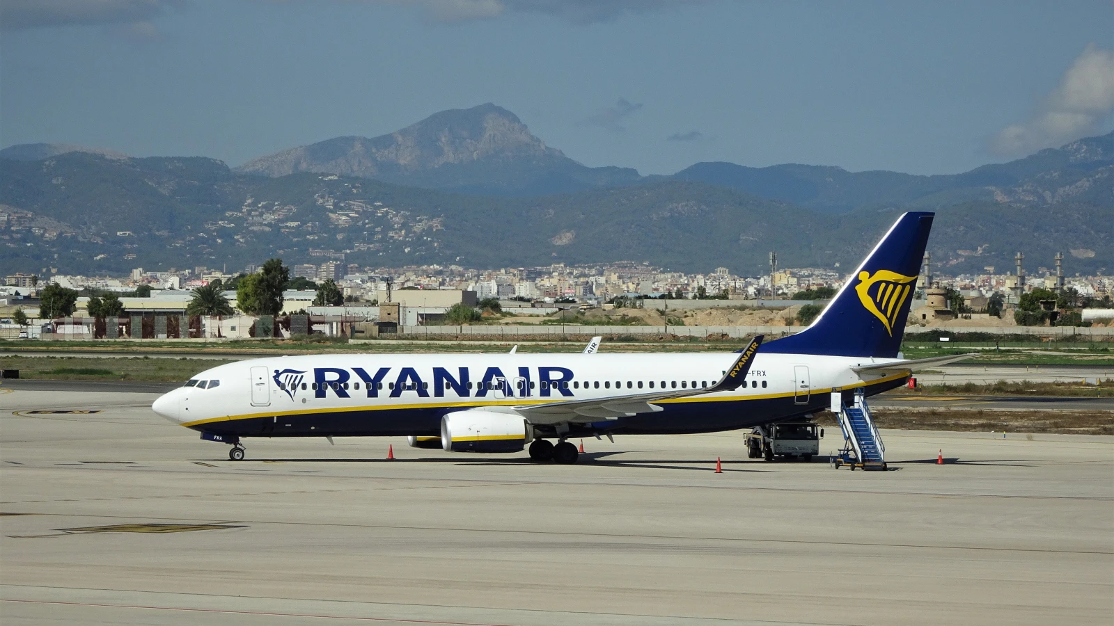 Boeing 737 at Palma de Mallorca Airport runway near car rental zone